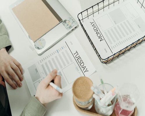 person organizing desk preparing for a productive and relaxed day
