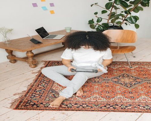 woman relaxing comfortably on a living room rug